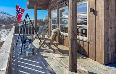 a horse sitting on a porch with a flag at 4 Bedroom Awesome Home In Vøringsfoss in Garden