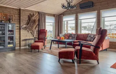 a living room with a couch and a table and chairs at 4 Bedroom Awesome Home In Vøringsfoss in Garden