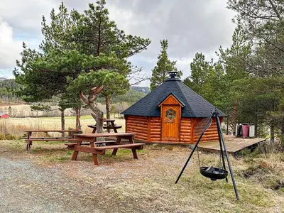 a cabin with a picnic table and a swing at 4 person holiday home in Lysøysundet in Teksdal