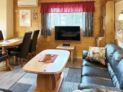 a living room with a couch and a table at 4 person holiday home in Lysøysundet in Teksdal