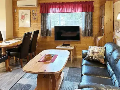 a living room with a couch and a table at 4 person holiday home in Lysøysundet in Teksdal