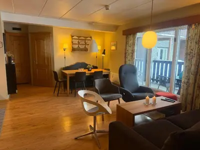 a living room with a couch and a table and chairs at Cozy Ground-Floor Apartment In Beitostølen in Beitostøl