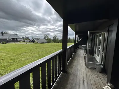 a porch of a house with a view of a field at Cozy Ground-Floor Apartment In Beitostølen in Beitostøl