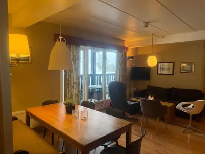 a living room with a table and a couch at Cozy Ground-Floor Apartment In Beitostølen in Beitostøl