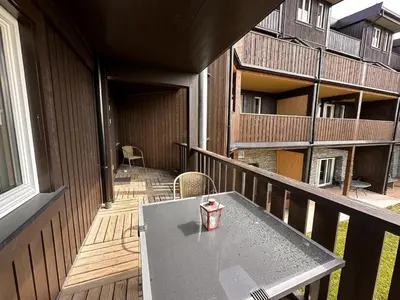 a table on the balcony of a building at Ideal Base For Exploring 2 Bedrooms & Balcony in Beitostøl