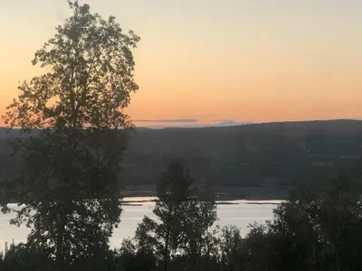a view of a river at sunset with trees at Golsfjellet - new modern cabin with fantastic view in Golsfjellet