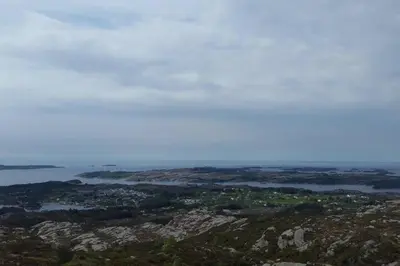 a view of the ocean from the top of a mountain at Seaside cottage with hot tub and sauna sleeps 11 in Forland