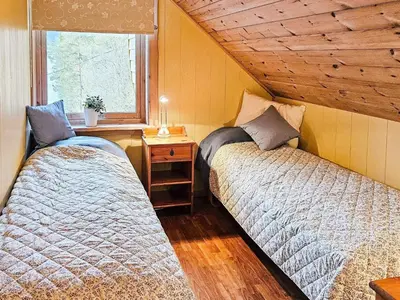 two beds in a room with a window at 6 person holiday home in Bygstad in Bygstad