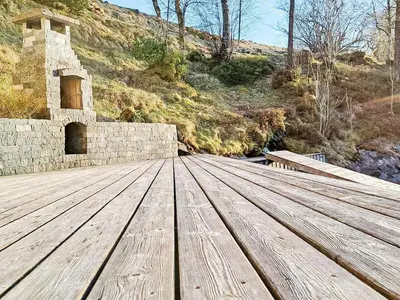 a wooden deck with a building in the background at 6 person holiday home in Bygstad in Bygstad
