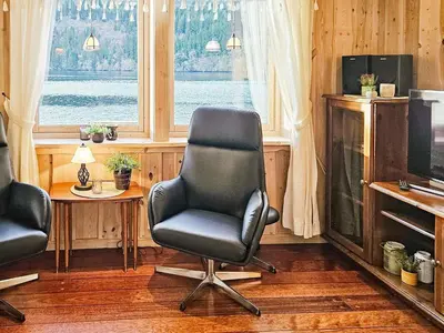 a room with a chair and a table and a television at 6 person holiday home in Bygstad in Bygstad