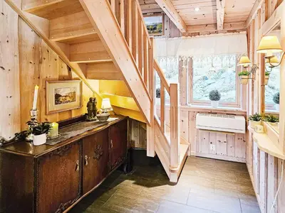 a kitchen with wooden walls and a staircase in a cabin at 6 person holiday home in Bygstad in Bygstad