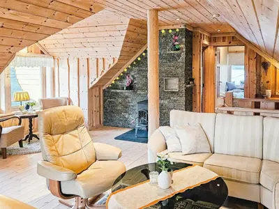 a living room with a couch and a fireplace at 6 person holiday home in Bygstad in Bygstad