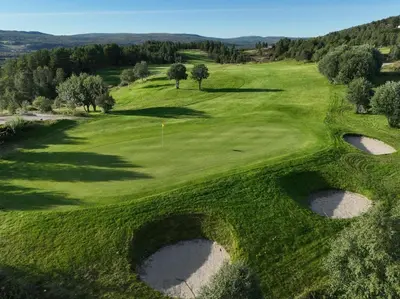 an overhead view of a golf course with a green at Private pearl in downtown Røros in Røros