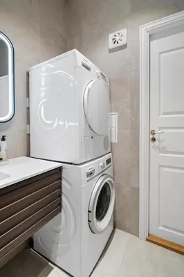 a white washer and dryer in a bathroom at Experience the luxury lifestyle 100m from Bryggen! in Bergen