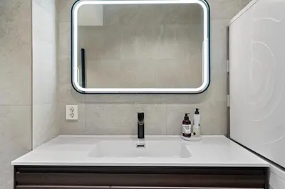 a bathroom with a sink and a mirror at Experience the luxury lifestyle 100m from Bryggen! in Bergen