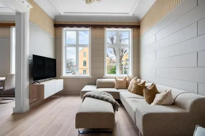 a living room with a couch and a tv at Experience the luxury lifestyle 100m from Bryggen! in Bergen
