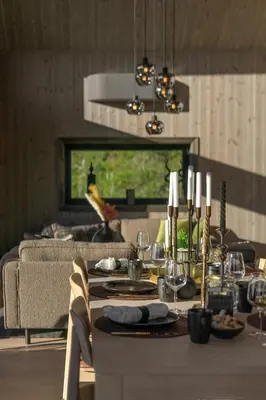 a living room with a table with wine glasses at Stryn Wiew Logde Tverrfjellet in Stryn
