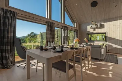 a dining room with a table and chairs with a view at Stryn Wiew Logde Tverrfjellet in Stryn