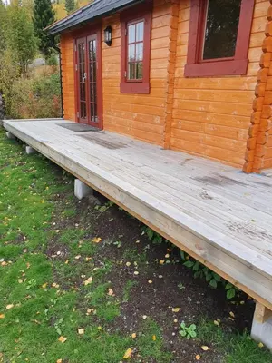 a large wooden deck in front of a cabin at Springaren - cabin close to Gaustatoppen in Tuddal