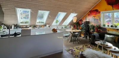 a kitchen with a bar and a living room at Nydelig leilighet i Bakklandet in Trondheim