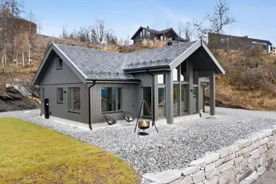 a tiny house with a roof on top of a yard at Hytte med fjellutsikt til nydelig natur in Sogndal
