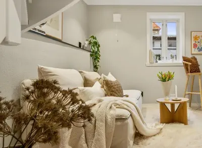 a living room with a white couch and a table at Stay l The Town House in Bergen