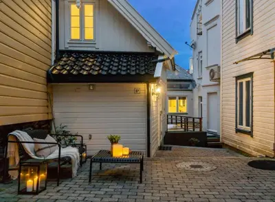 a garage with a bench and a table on a patio at Stay l The Town House in Bergen