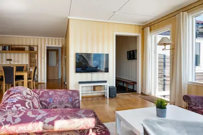 a living room with a couch and a table at Villa Ocean View in Askøy
