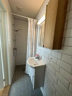 a bathroom with a sink and a shower at Leilighet sentralt i Stryn in Stryn