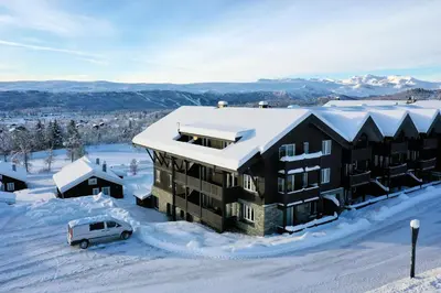 an aerial view of a building in the snow at Bright and Modern penthouse apartment in Beitostøl