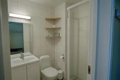 a bathroom with a toilet and a sink and a shower at Bright and Modern penthouse apartment in Beitostøl