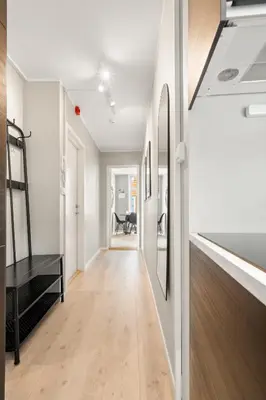 an empty hallway with white walls and wood flooring at Bergen Beds Apartments I Luxury 250m from Bryggen in Bergen