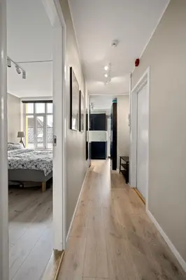 a hallway leading to a bedroom with a bed at Bergen Beds Apartments I Luxury 250m from Bryggen in Bergen