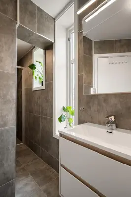 a bathroom with a sink and a mirror at Bergen Beds Apartments I Luxury 250m from Bryggen in Bergen