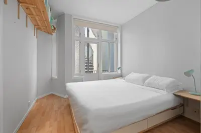 a white bed in a room with a window at Your Local Bergen Dream In The Heart Of The city in Bergen