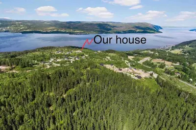 an aerial view of a house on a hill with a lake at Annex Fjara greater Oslos best view sleeps 10 guests in 3 bedrooms in Stange