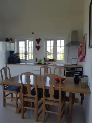 a kitchen with a wooden table and four chairs at Annex Fjara greater Oslos best view sleeps 10 guests in 3 bedrooms in Stange