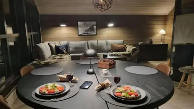 a living room with a table with two plates of food at Alpinvegen 22B, Trysil Alpin 22B in Trysil