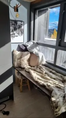 a person laying on a bed in a room with a window at Alpinvegen 22B, Trysil Alpin 22B in Trysil