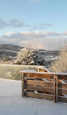 a wooden bench sitting on top of a snow covered field at Holiday home in Steinkjer in Steinkjer
