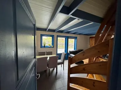 a room with a dining room with a table and chairs at Nautnes Coastal Haven in Nautnes