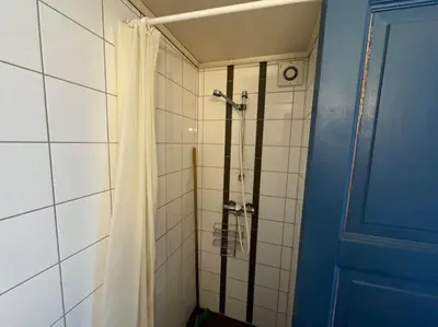 a bathroom with a shower with a shower curtain at Nautnes Coastal Haven in Nautnes