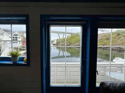 a window with a view of a body of water at Nautnes Coastal Haven in Nautnes