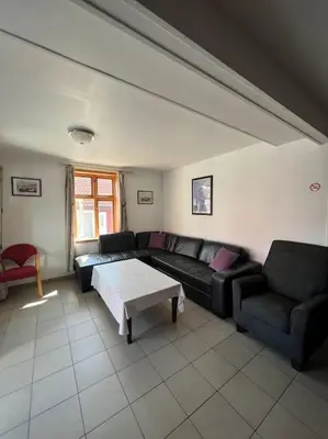 a living room with a couch and a table at Fishermans Apartment A13 in Nautnes
