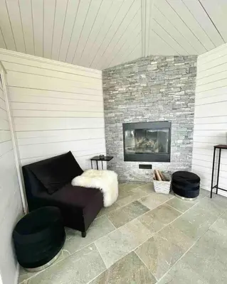 a living room with a couch and a fireplace at Villa Freya with stunning sea view in Kristiansund