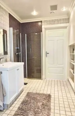 a bathroom with a shower and a white door at Villa Freya with stunning sea view in Kristiansund