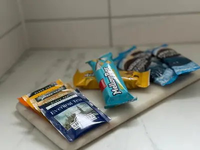 a counter top with toothpaste and a bag of chips at StarView Trolltunga Apartment in Odda