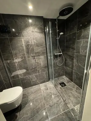 a bathroom with a shower and a toilet at StarView Trolltunga Apartment in Odda