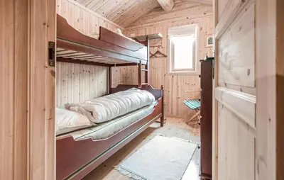 a room with two bunk beds in a cabin at 5 Bedroom Gorgeous Home In Engerdal in Nymoen