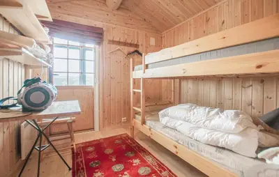 a bedroom with bunk beds in a wooden cabin at 5 Bedroom Gorgeous Home In Engerdal in Nymoen